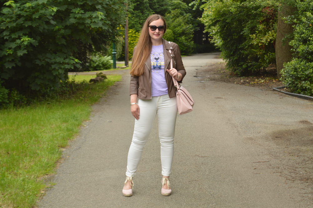White jeans lilac top and biker jacket