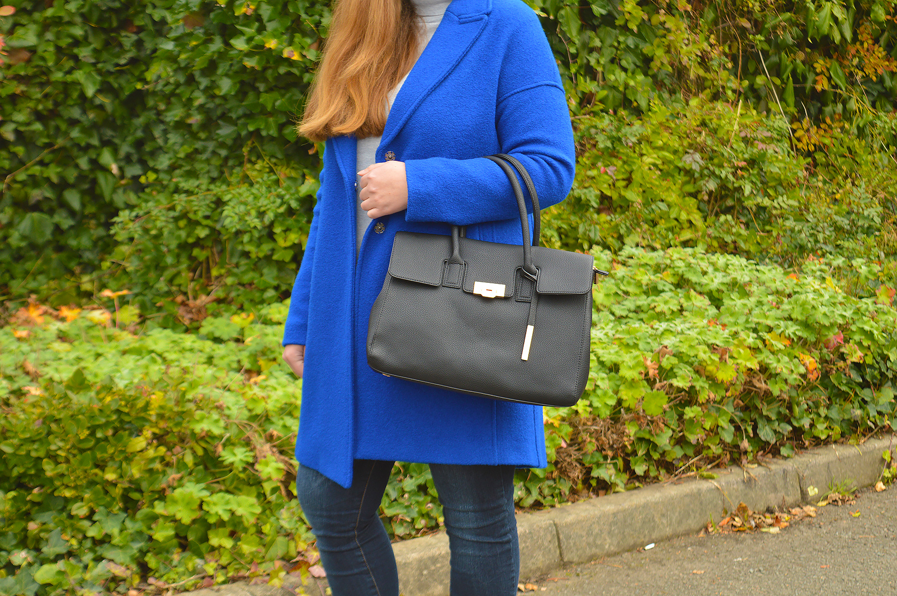 Black handbag and blue coat