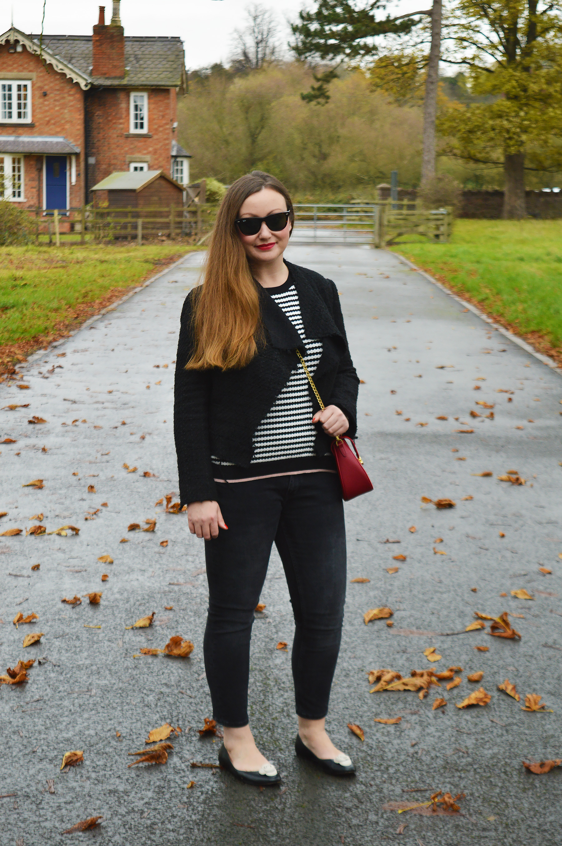 Black and white outfit with a pop of red bag