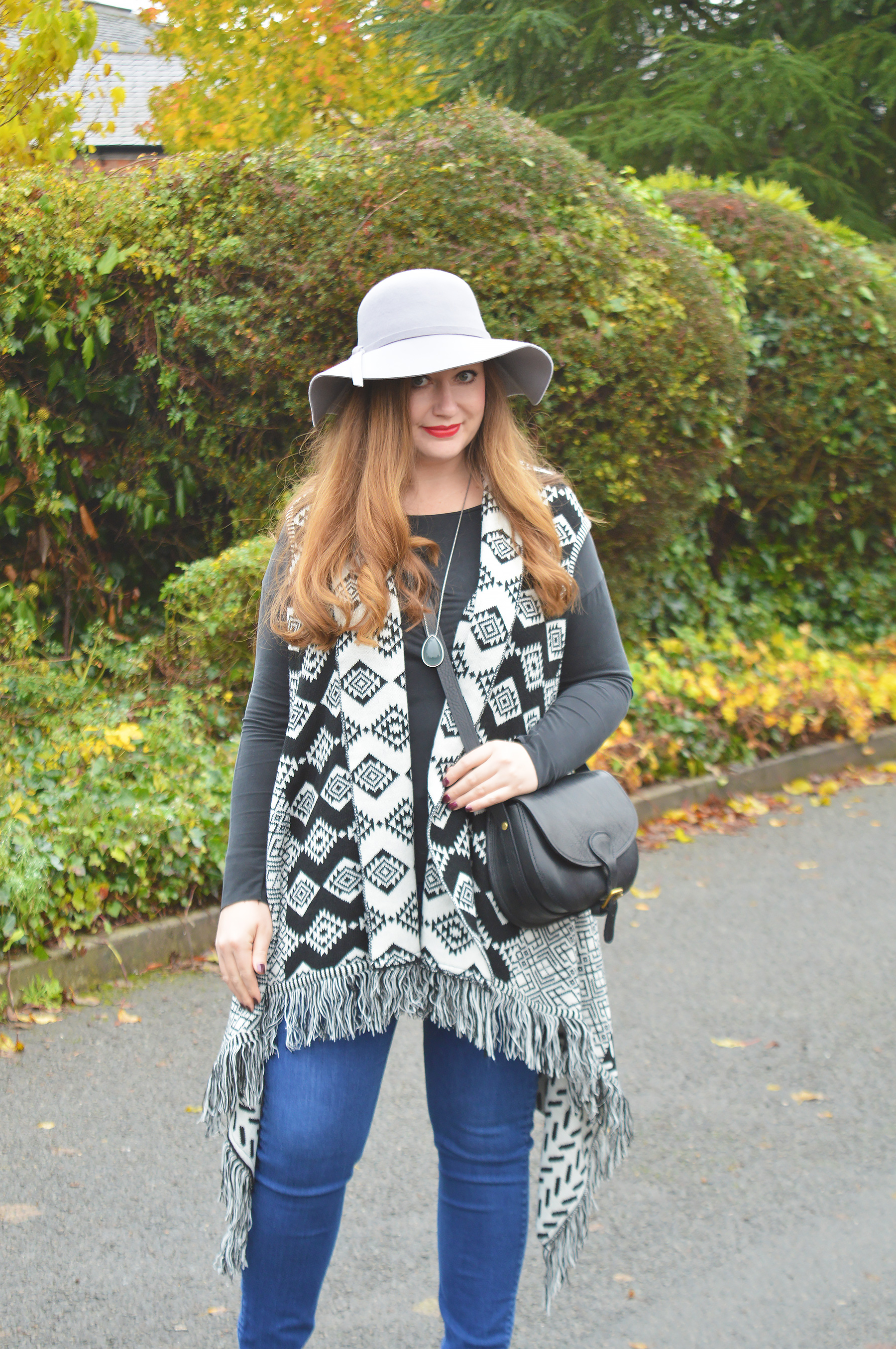 Boho style outfit with floppy hat and fringed cardigan