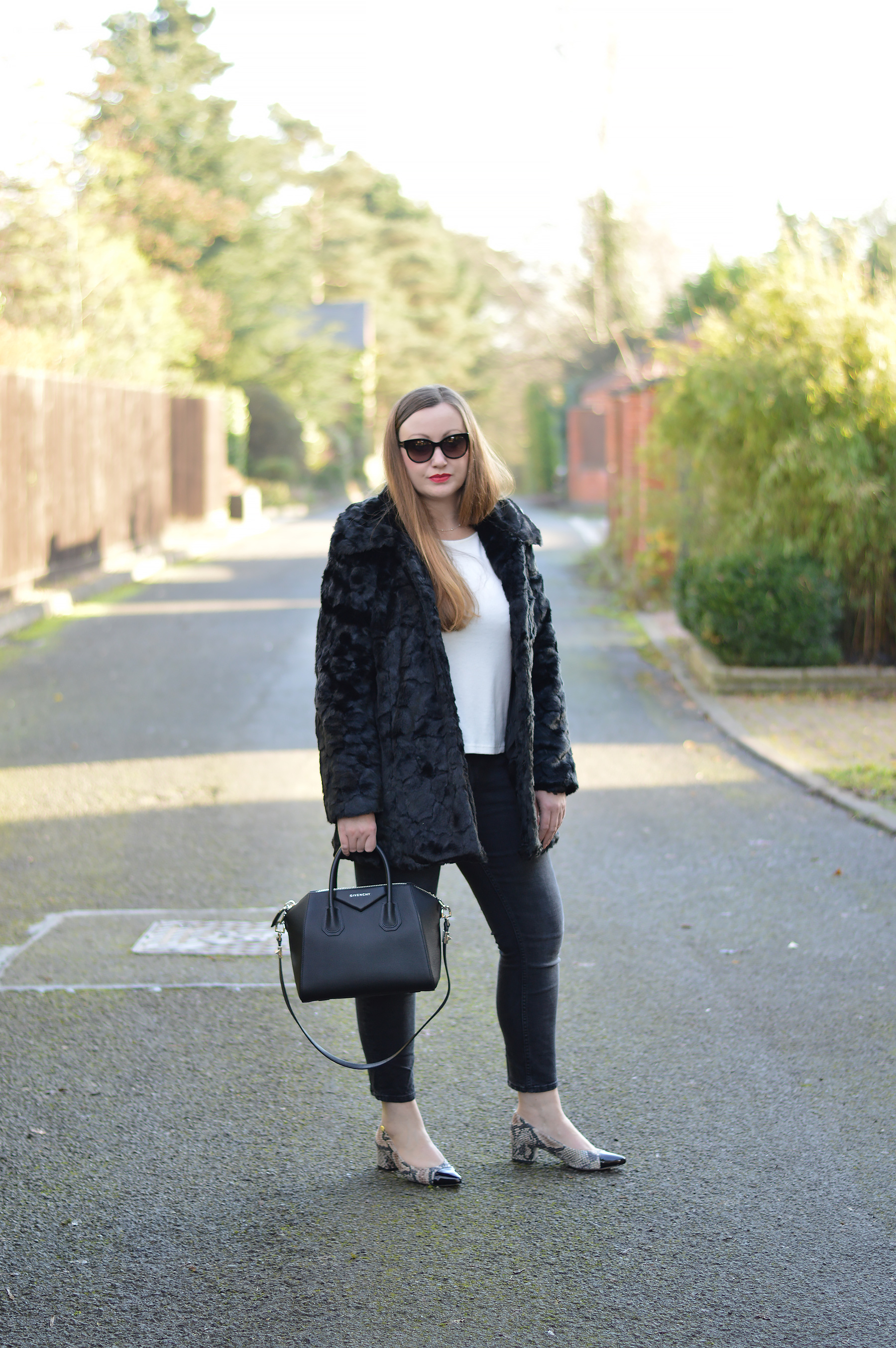 Black Fur coat with white top and black jeans
