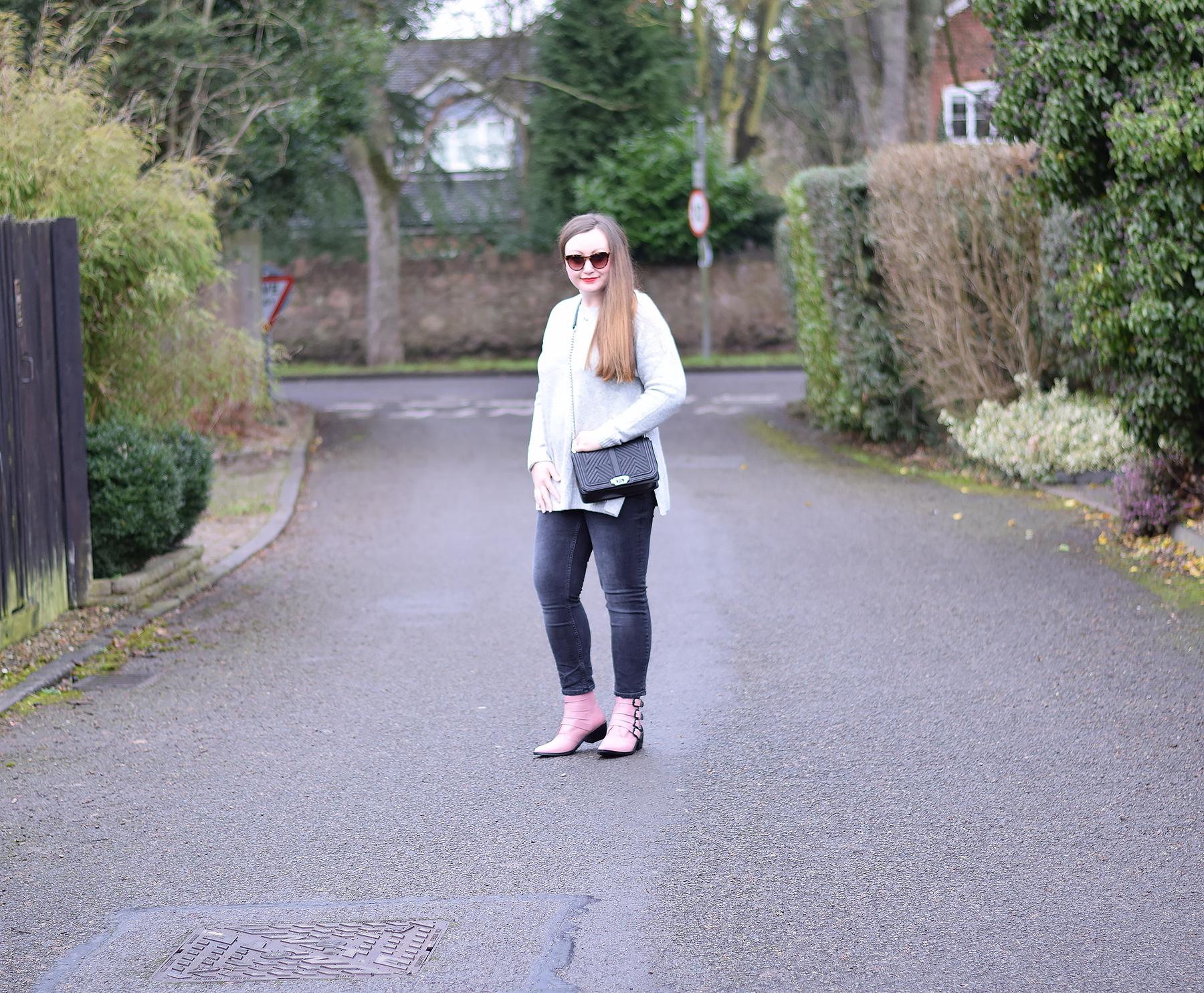 Grey jumper black jeans and pink ankle boots