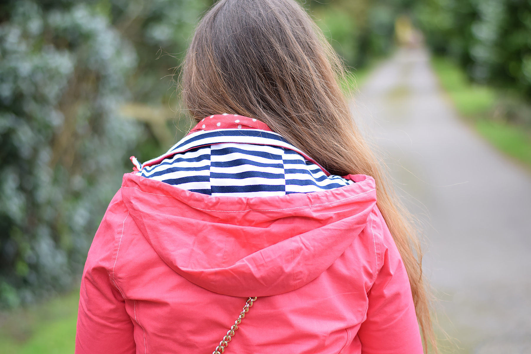 Pink raincoat with striped hood