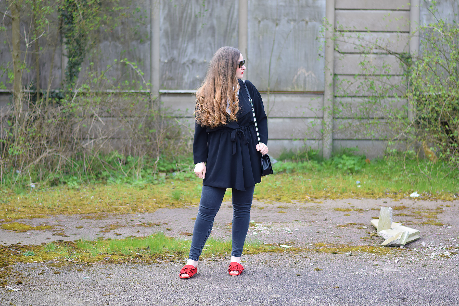All black outfit with red shoes
