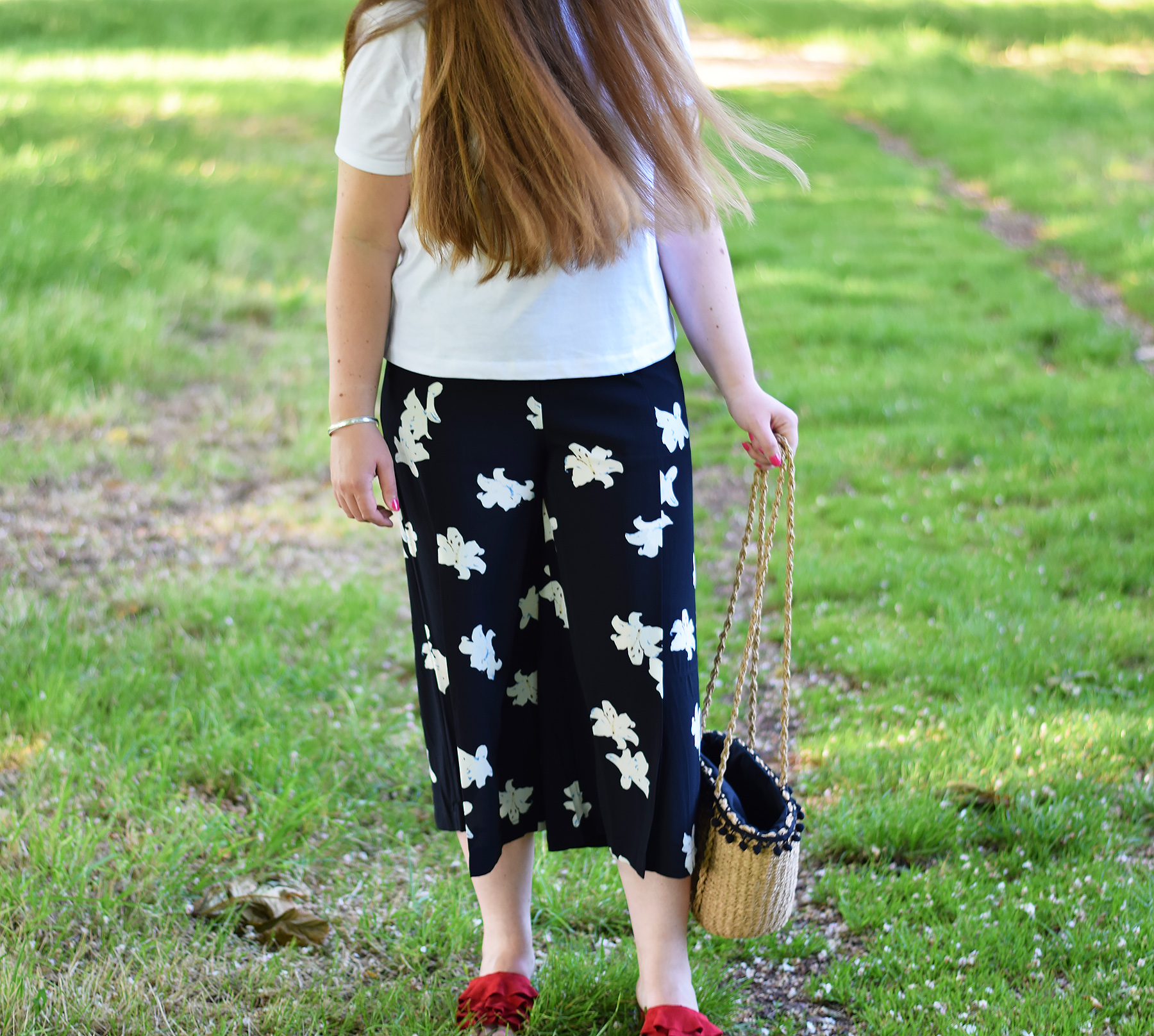 Floral trousers and red slides
