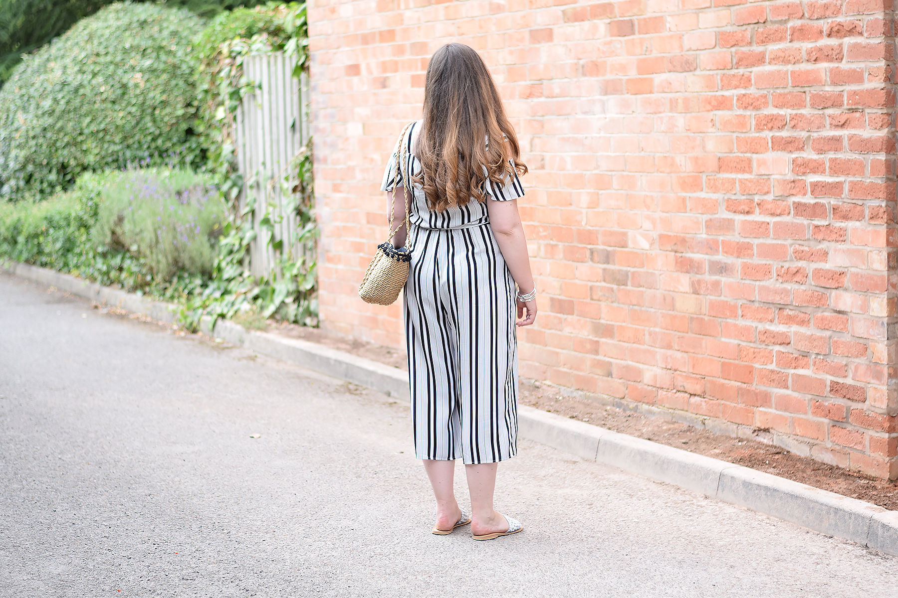Striped jumpsuit with cold shoulder and cropped length
