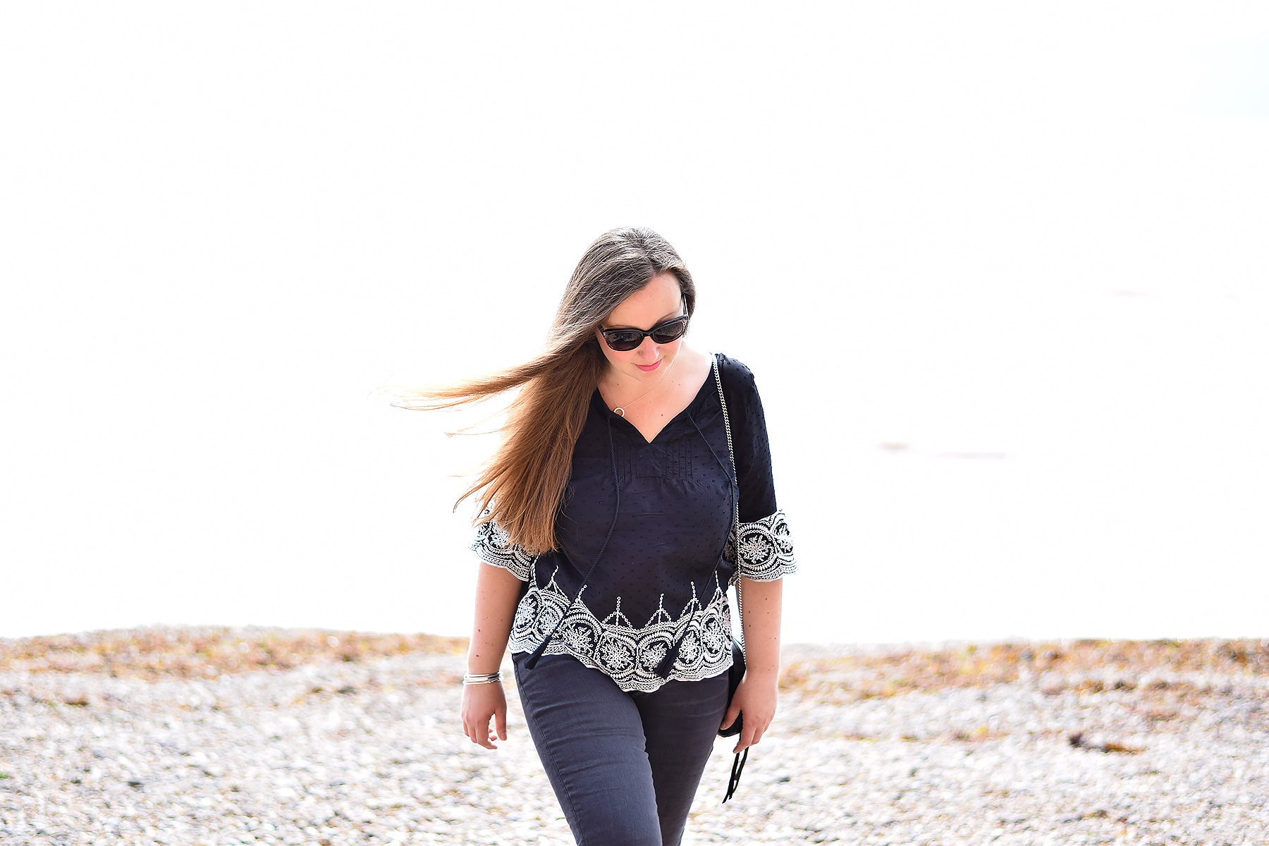 Having a walk on the beach in a black and white embroidered coverup