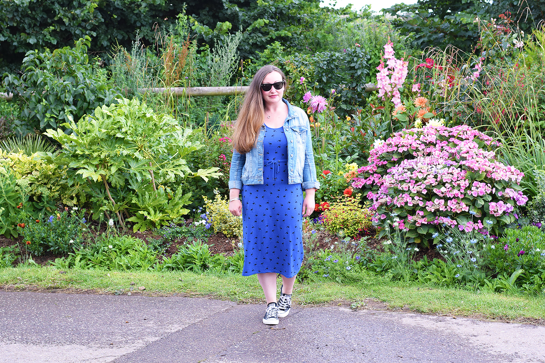Blogger wearing a blue boden midi dress with denim jacket and concverse