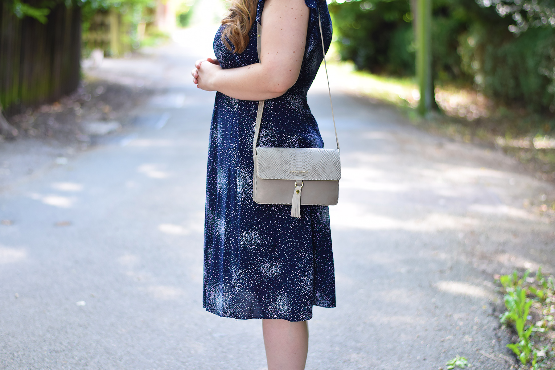 laura Ashley Navu Starburst dress and tassel detail bag