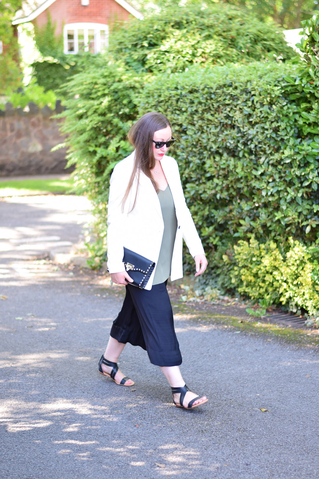 Blazer and Cropped trousers outfit with sandals and valentino rockstud clutch