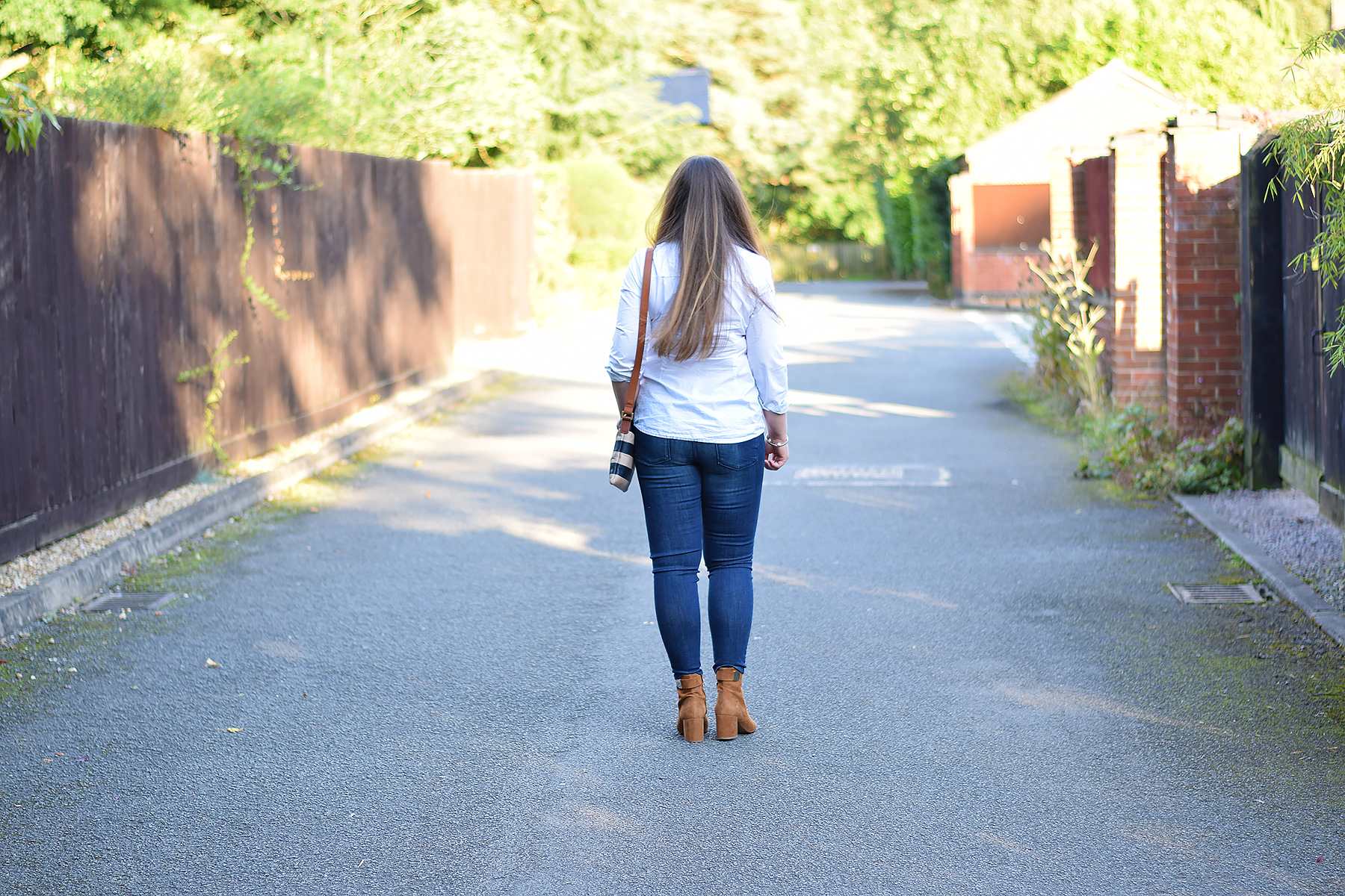 Tan ankle boots with jeans and white shirt