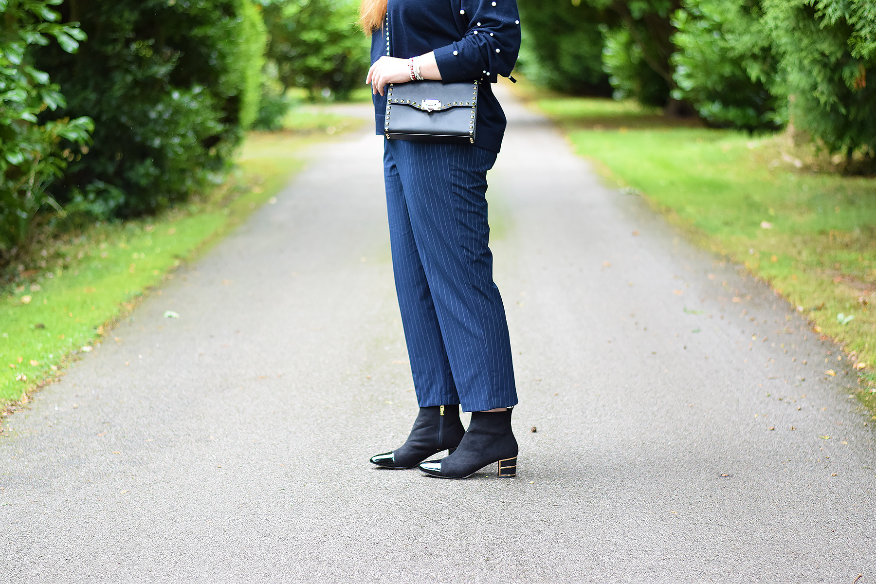 Lotus toe cap ankle boots with zara trousers and Valentino rockstud bag