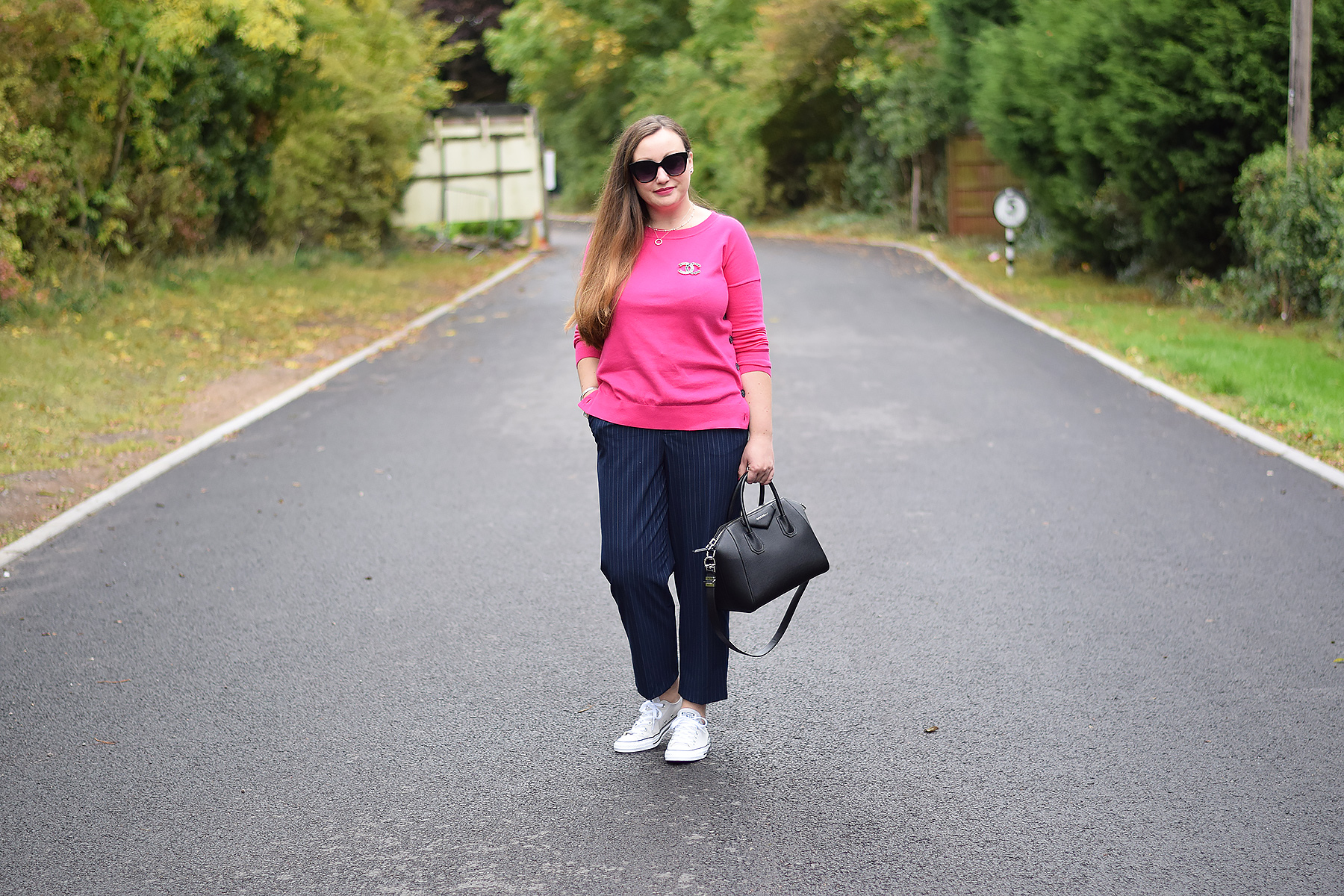 Light grey converse with cropped trousers and a pink sweater