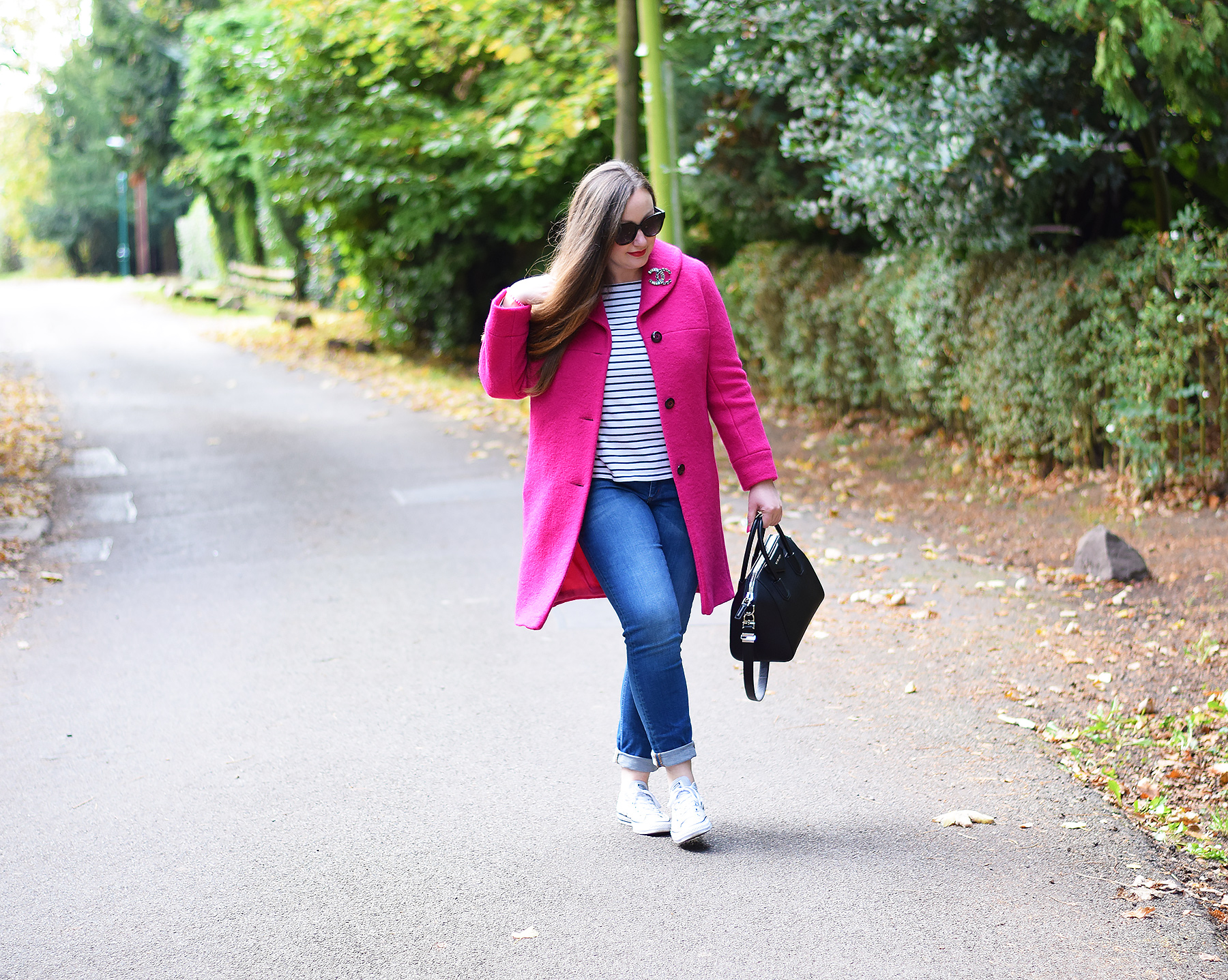 Bright pink coat over a striped top