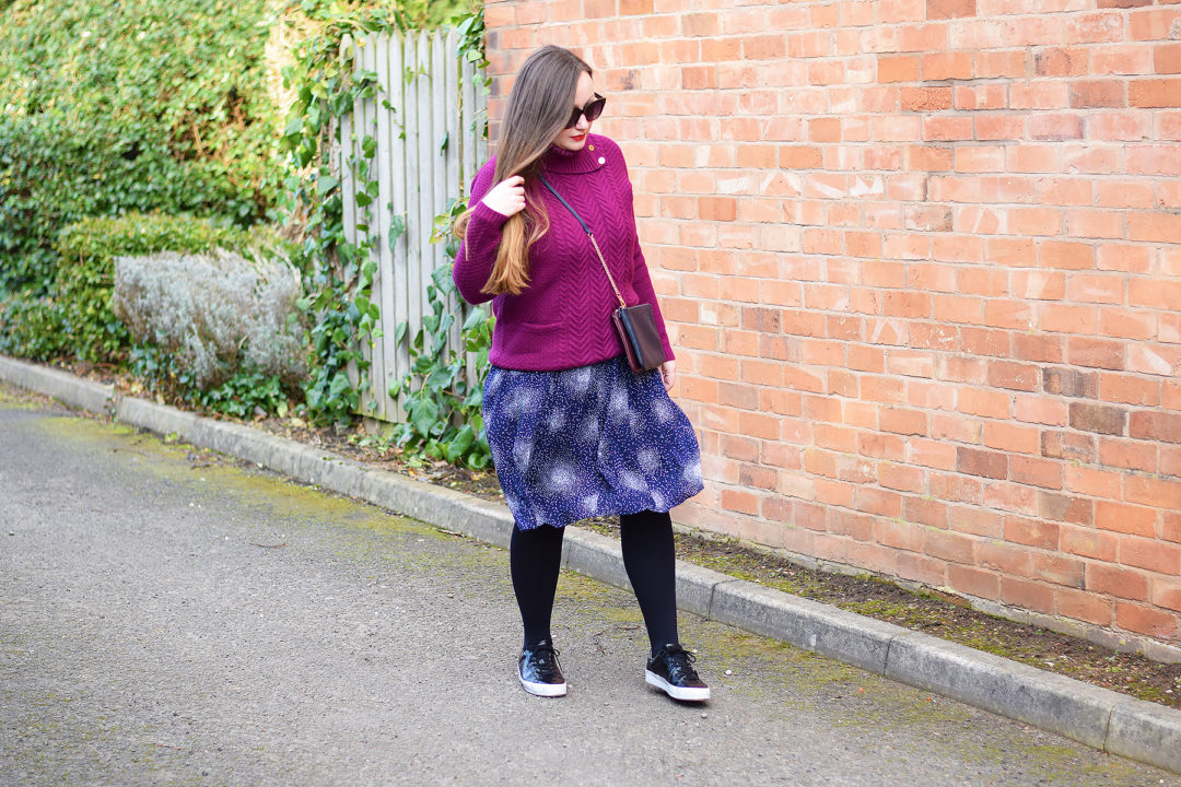 Layering a chunky knit over a midi dress