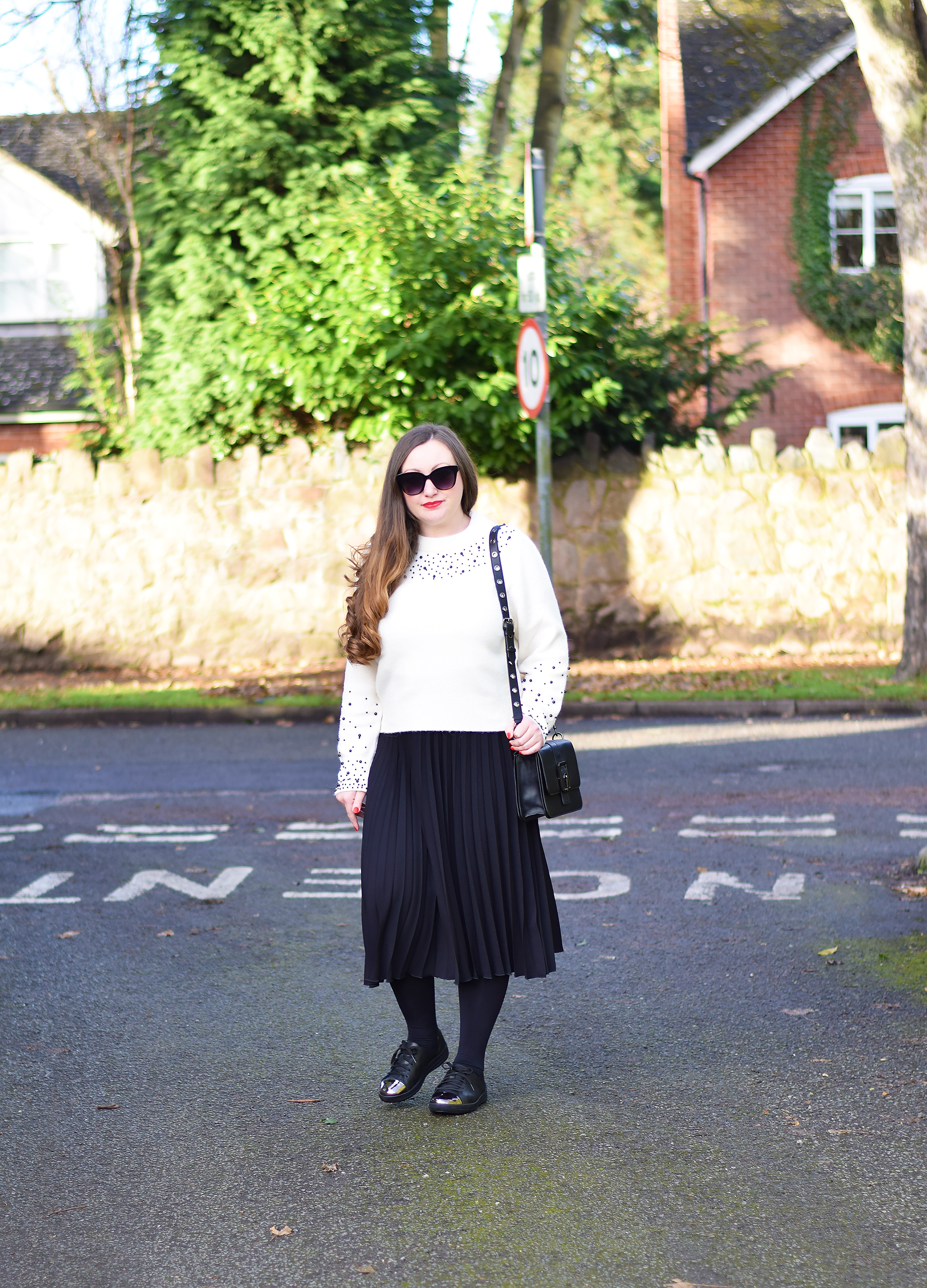 Pleated skirt with tights and trainers outfit