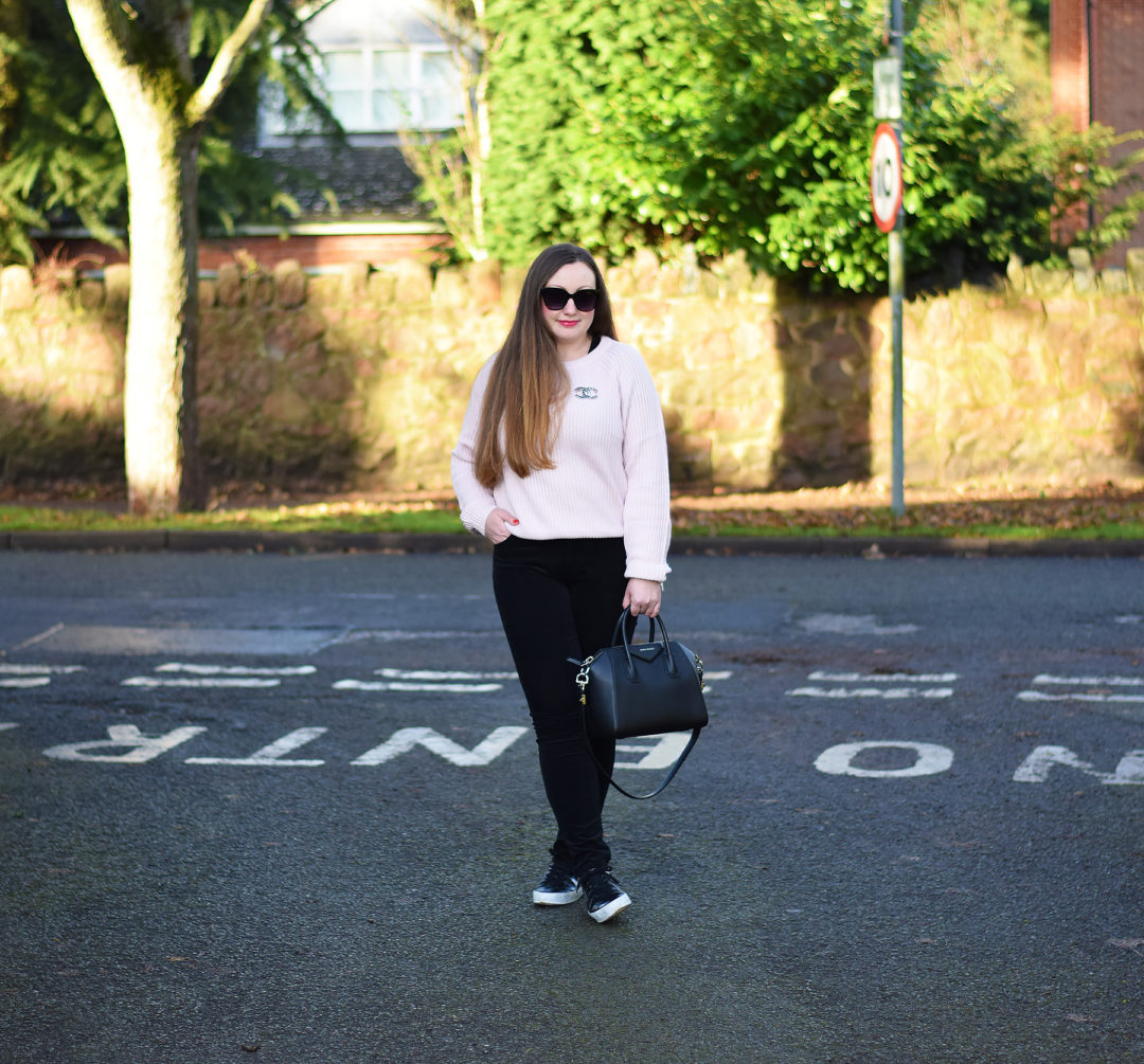 Pink sweater with black cord jeans