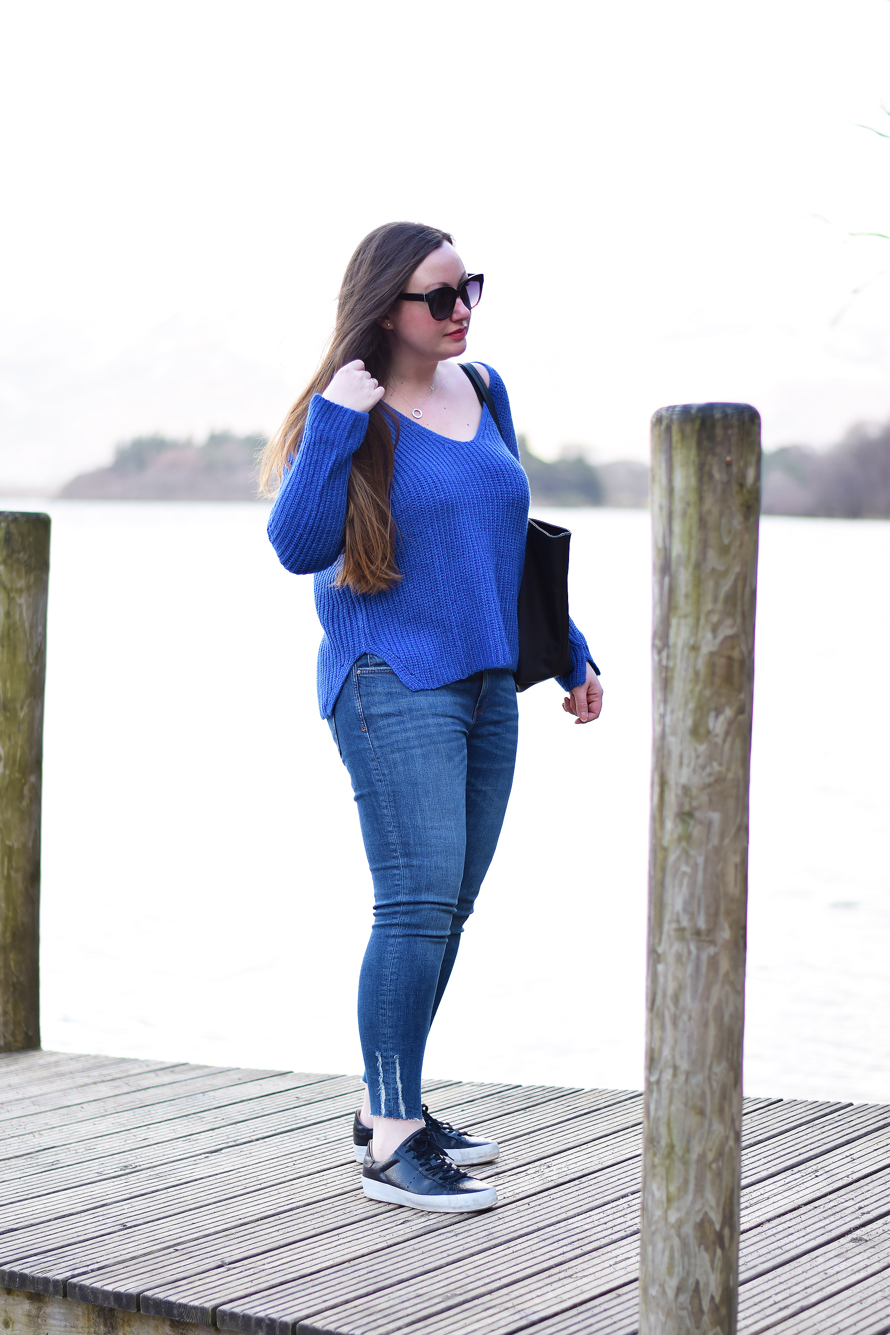 Bright blue jumper outfit with jeans and trainers