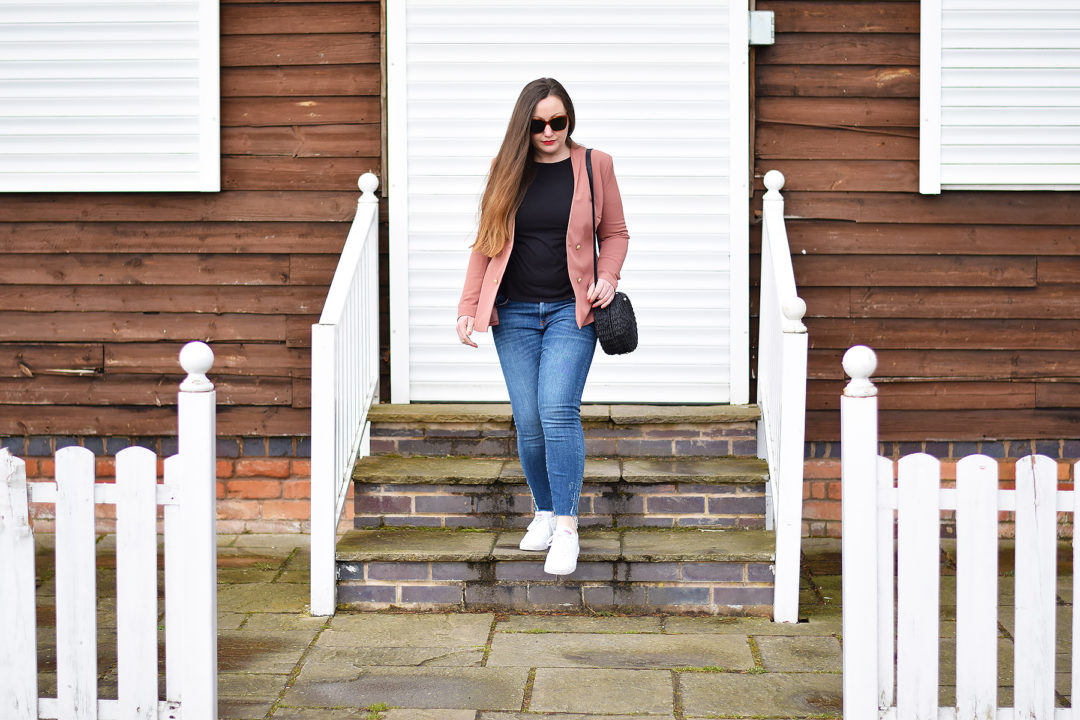 Blazer and jeans outfit with a straw bag