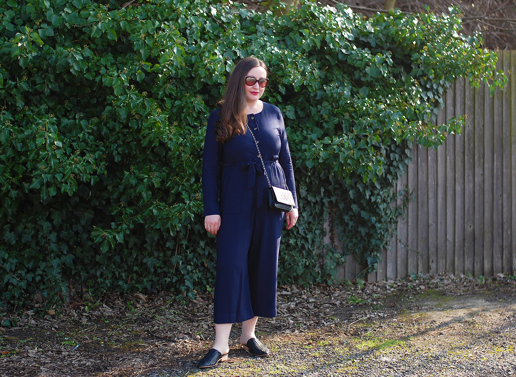 Navy Jumpsuit With Black Bag and Shoes Outfit