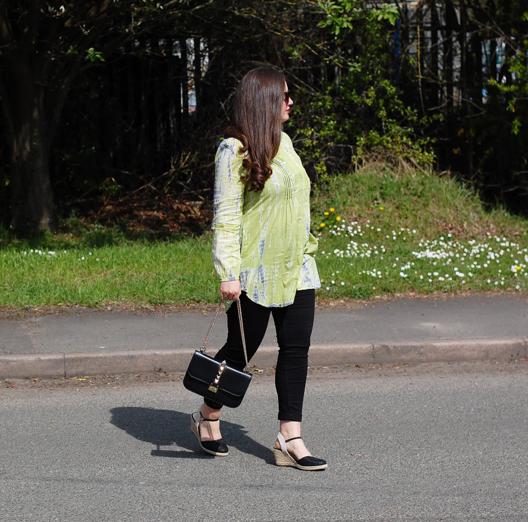 Neon green tie dye blouse with black espadrilles and jeans