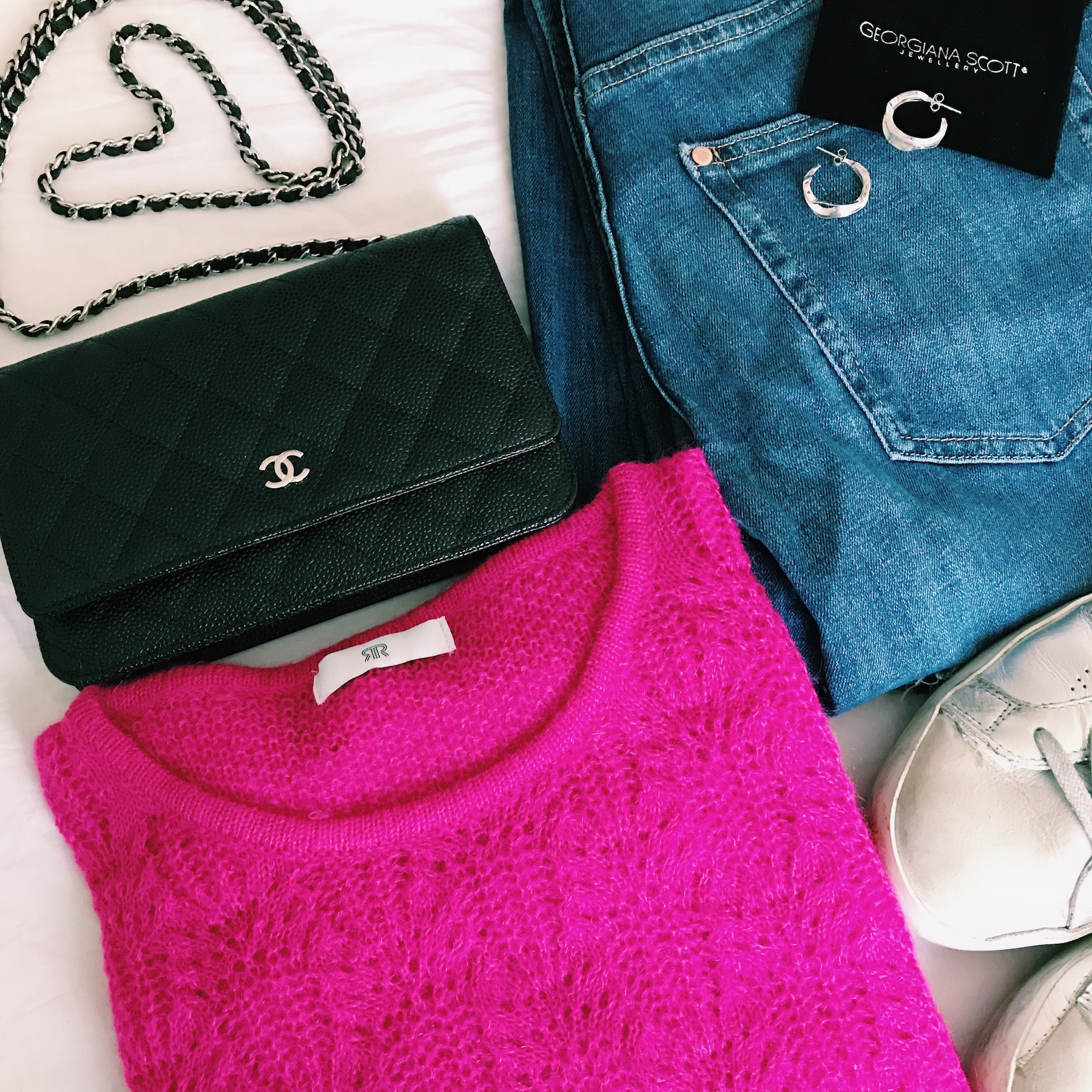 Outfit Flatlay With Pink Jumper Jeans and Georgiana Scott Hoop Earrings