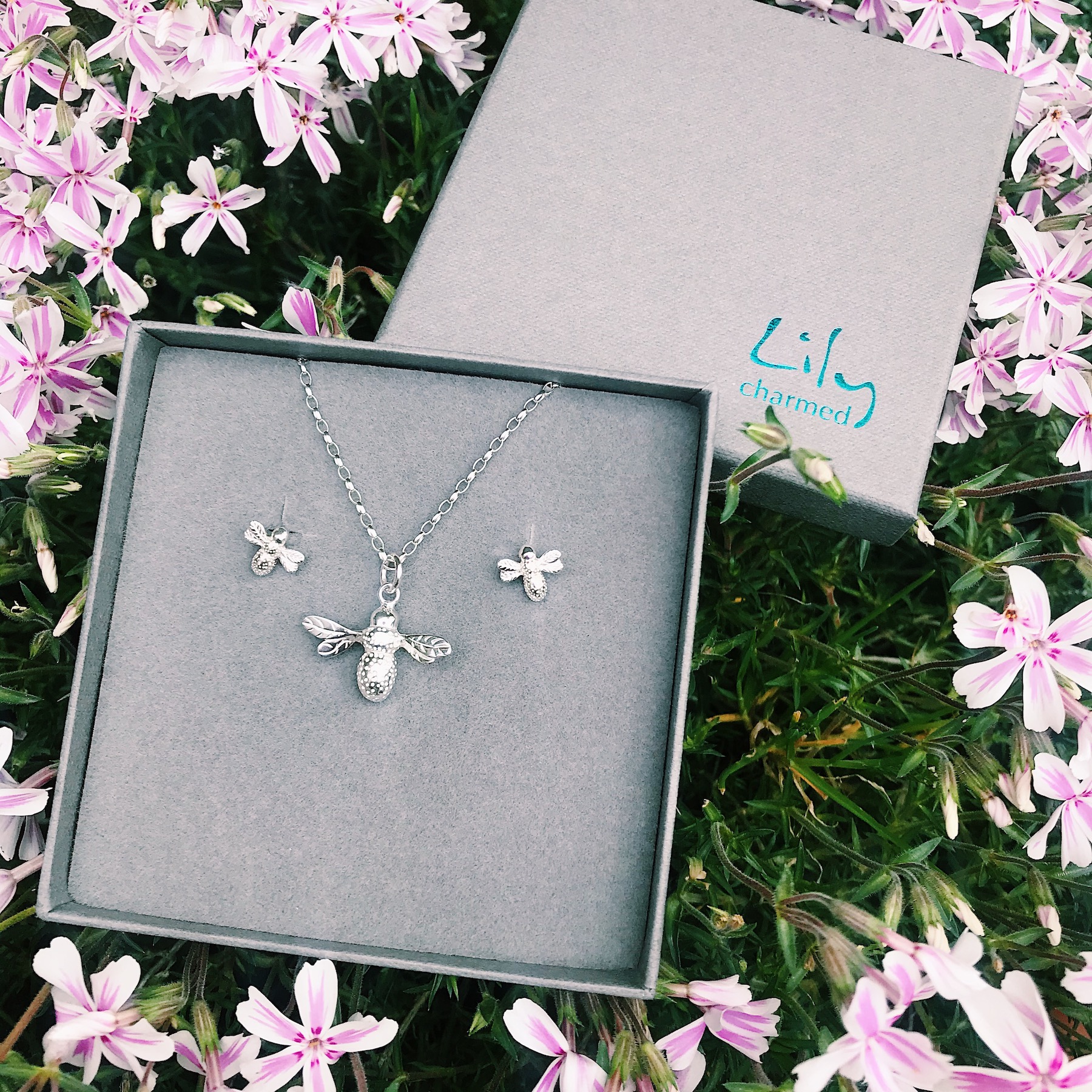 A picture of the Bee Necklace and earrings set from lily Charmed