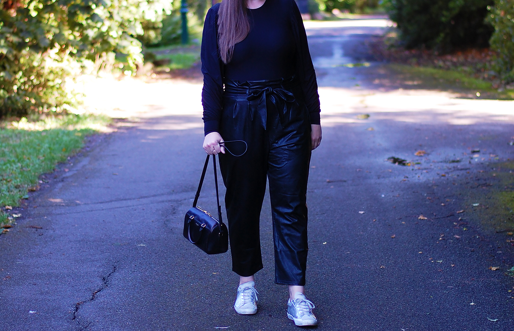 all black outfit featuring faux leather trousers