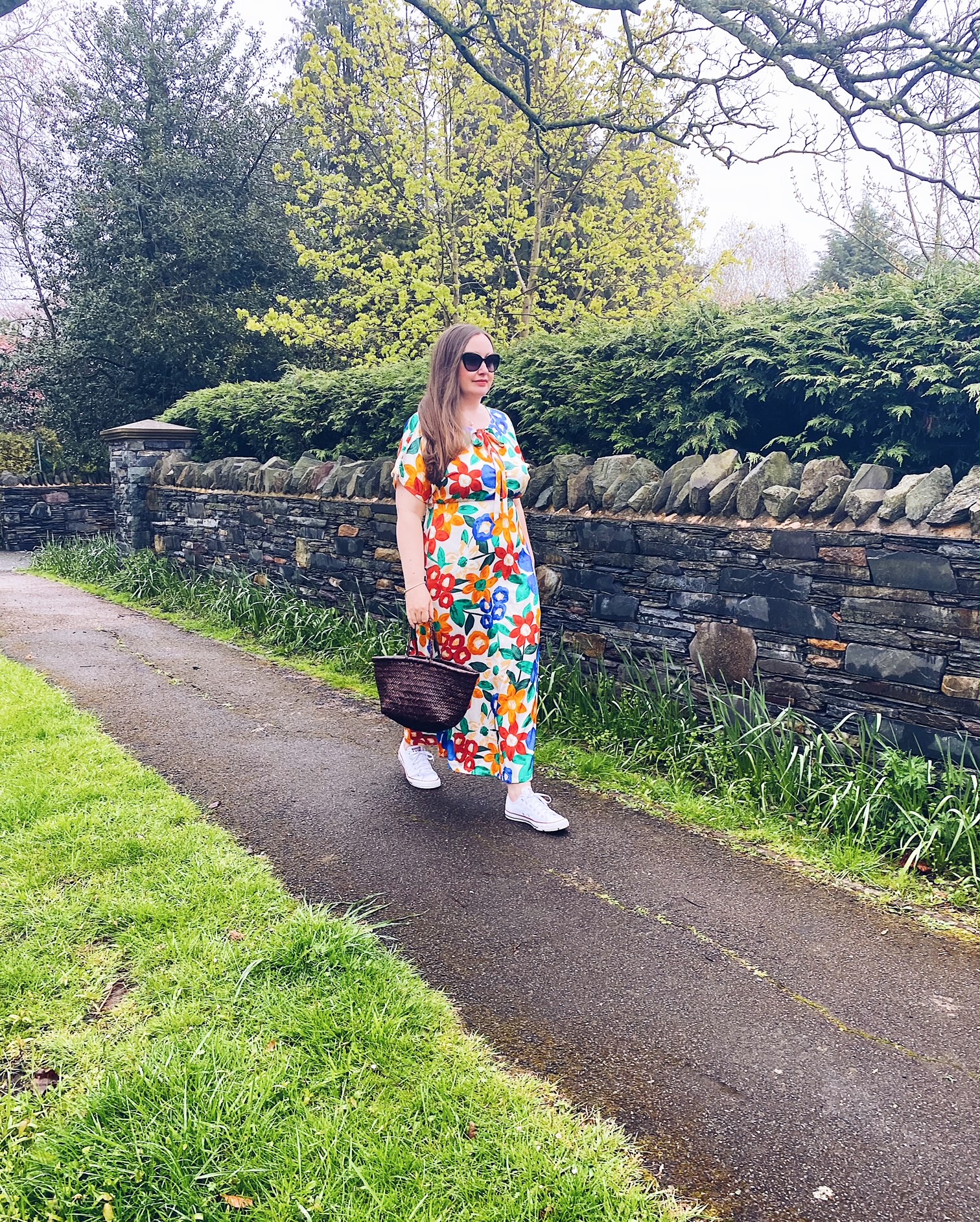Floral maxi dress with trainers and basket bag