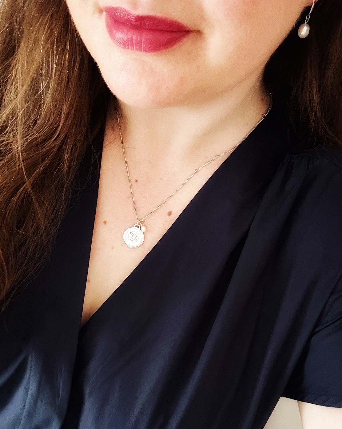 Claudia Bradby CB Zodiacs Pendant Necklace and classic pearl drop earrings being worn